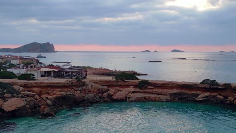 Nice-aerial-top-view-flight-Yoga-Girl-points-sunset-cliff-beach-island-ibiza-Spain