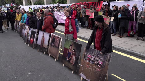 Extinction-Rebellion-activists-line-up-with-photographic-placards-depicting-climate-change-disasters-outside-the-Intercontinental-Hotel-in-Mayfair-where-the-Energy-Intelligence-Forum-is-taking-place
