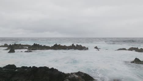 Las-Olas-Del-Mar-Golpean-Las-Rocas-Negras-Durante-El-Día-Nublado.