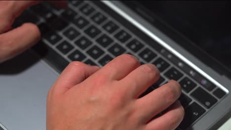 Close-up-office-typing-on-a-laptop-keyboard-in-the-office