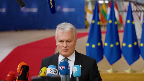 Lithuanian-President-Gitanas-Nausėda-talking-to-the-press-at-the-European-Council-summit-in-Brussels,-Belgium---Medium-shot