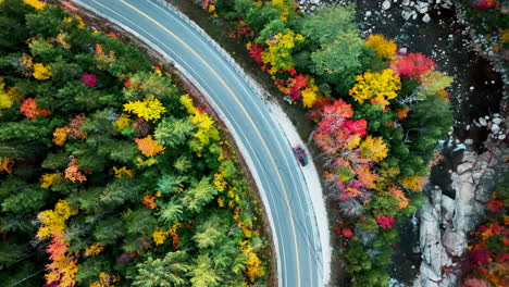 Top-Down-Drone-Shot-of-a-Van-on-Kancamagus-Highway-New-Hampshire-during-Fall-Foliage