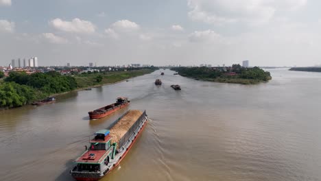 Cargo-vessels-travelling-along-Red-River,-Hanoi-city,-Vietnam