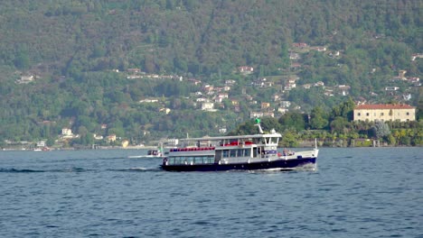 A-cruise-ship-travels-across-Lake-Maggiore-near-Stresa,-Piedmont,-Italy
