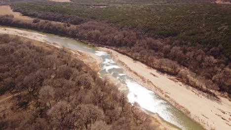 Brazos-River-in-Texas-Flowing-Through-Sandy-Beach-Bars-and-Trees-In-Winter-Arid-Dry-Area