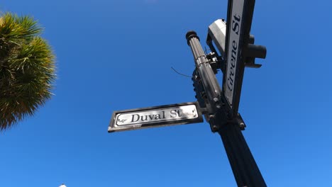 Duval-Street-and-Greene-St-signs,-Key-West-against-blue-sky,-Florida