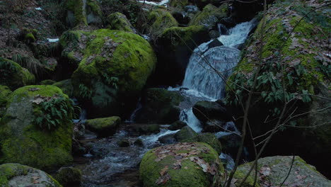 Forward-moving-super-slow-motion-shot-of-a-creek-waterfall-in-the-black-forest-in-autumn