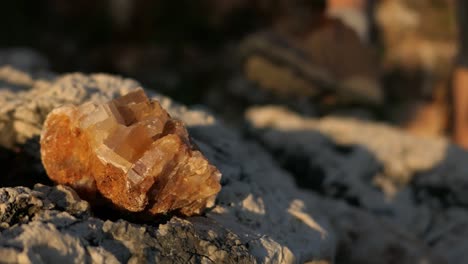 Man-discovering-shiny-crystal-mineral-rock-outdoors,-beautiful-stone-discovery