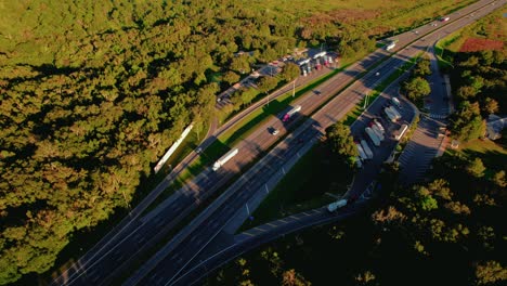 Aerial-of-semi-truck-rest-area-in-Florida-with-highway,-rest-area-provides-a-welcoming-and-convenient-stop-for-those-on-the-road