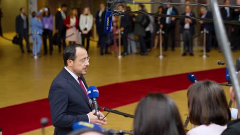 Cyprus'-President-Nikos-Christodoulides-talking-to-the-press-at-the-European-Council-summit-in-Brussels,-Belgium---Medium-shot