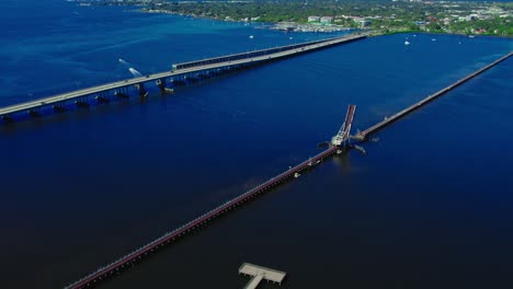 Aerial-during-sunshine-day-over-CSX-Train-Bridge,-Bascule-bridge-open,-Bradenton-Florida