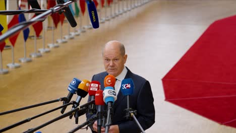Chancellor-of-Germany-Olaf-Scholz-talking-to-the-press-at-the-European-Council-summit-in-Brussels,-Belgium---Medium-shot