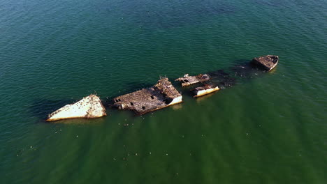Aerial-view-around-a-shipwreck-on-the-coast-of-sunny-Rio-del-Mar,-CA,-USA