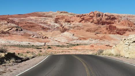 Travel-thirst-on-the-road-in-the-state-park-the-Valley-of-Fire,-in-the-desert-hills-of-Nevada