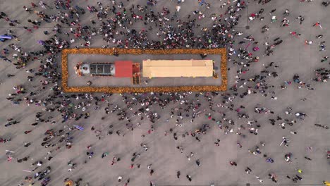 A-bird's-eye-drone-video-capturing-a-crowd-around-the-Day-of-the-Dead-offering-in-Mexico-City's-historic-center