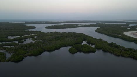 Drone-moves-forward-flying-over-these-islands-and-mangrove-forests-in-this-extended-body-of-water-at-a-coastal-area-in-Porlamar,-Margarita-Island,-Venezuela