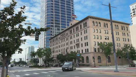 Skyscrapers-and-YMCA-building-with-street-crossing-in-Downtown-San-Diego,-CA