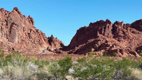 Passing-rock-formations-and-hills-in-the-Valley-of-Fire-state-park,-Nevada