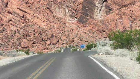Road-trio-Valley-of-Fire-Mohave-desert-Nevada-with-red-sandstone-hills-and-spars-green-vegetation