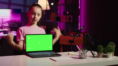 Kid-influencer-in-home-studio-using-recording-gear-to-record-review-of-mockup-laptop