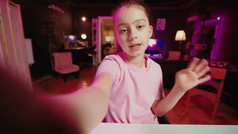 Cute-kid-holding-selfie-smartphone-camera,-filming-herself-doing-room-tour
