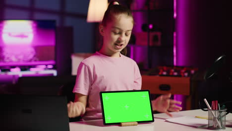 Child-media-star-showing-isolated-screen-tablet-to-fans,-unpacking-it-and-presenting-specifications