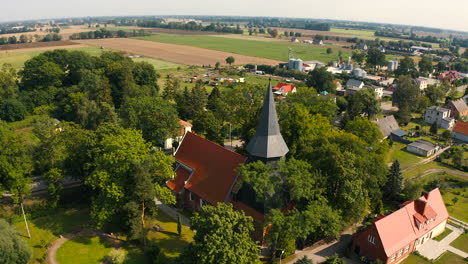 Aerial-shot,-flying-around-beautiful-medieval-church-in-Trutnowy,-Poland