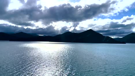 Dark-fluffy-clouds-over-coastal-mountains-of-Cook-Strait,-New-Zealand