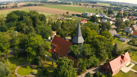 Aerial-shot-of-panorama-of-beautiful-medieval-church-in-Trutnowy,-Poland
