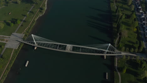 Aerial-revealing-shot-of-a-bridge-over-the-river-Rhine-connecting-France-with-Germany-at-summer