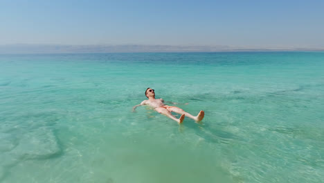 Young-Caucasian-Man-Floating-in-the-Dead-Sea