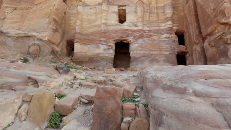 Tilt-up-shot-of-building-carved-into-rock,-Nabataean-architecture,-Petra,-Jordan