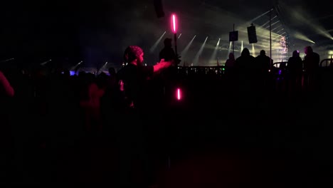 Raver-performs-a-spinning-light-show-with-glow-sticks-at-a-festival-concert