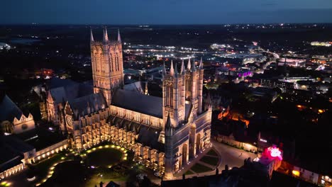 Aerial-drone-footage-captures-the-renowned-Lincoln-Cathedral-in-Lincolnshire,-UK,-at-dusk,-highlighting-its-magnificent-illuminated-Gothic-architecture
