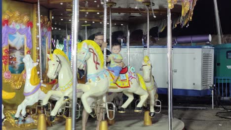 Little-kids-dancing-carnival-animal-rides,-little-kids-enjoying-vacation-with-their-parents