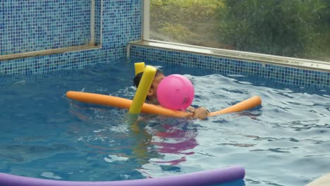 A-small-young-boy-playing-in-a-swimming-pool