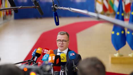 Finish-Prime-Minister-Petteri-Orpo-giving-a-statement-at-the-European-Council-summit-in-Brussels,-Belgium---Slow-motion