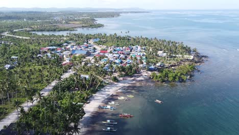 Fishing-boats-and-Cabitoonan-seaside-beach-village-on-coast-of-Siargao-island