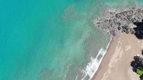 Costa-Rica-beach-drone-top-view-showing-sea,-shore-and-palm-tree-forest-in-Corcovado-National-Park-on-a-sunny-day-in-the-pacific-ocean
