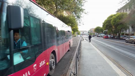 Red-ATAC-Bus-Driving-on-City-Street-in-Rome,-Italy