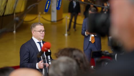 Finish-Prime-Minister-Petteri-Orpo-with-a-statement-at-the-European-Council-summit-in-Brussels,-Belgium---Medium-shot,-Slow-motion