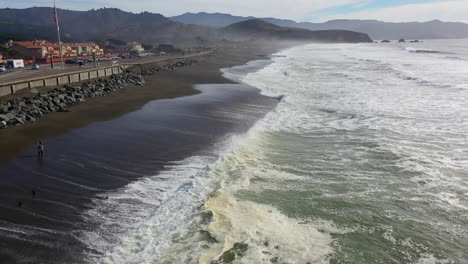 Aerial-view-flying-over-waves-at-the-Sharp-Park-Beach-in-sunny-Pacifica,-USA
