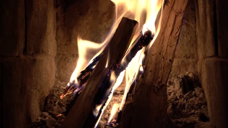 Medium-shot-of-wooden-logs-burning-in-an-indoor-fireplace