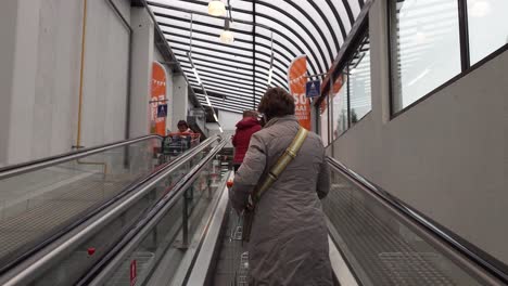 POV-of-person-going-up-with-electric-escalator-to-shop-in-the-discount-supermarket-Colruyt---Brussels,-Belgium