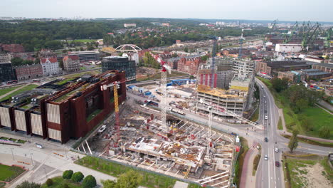 Aerial-view-of-Gdańsk-cityscape-with-construction,-roads,-and-historic-architecture