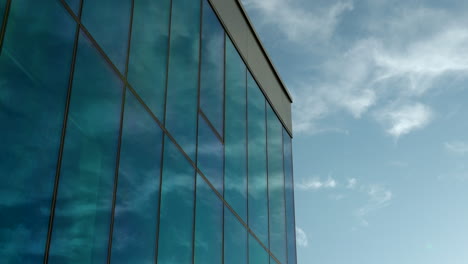 Reflection-of-blue-sky-and-clouds-on-modern-glass-building-facade