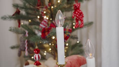 Electric-candles-with-Christmas-tree-backdrop