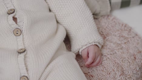 Baby's-Hand-in-Knitted-Sweater---Close-up
