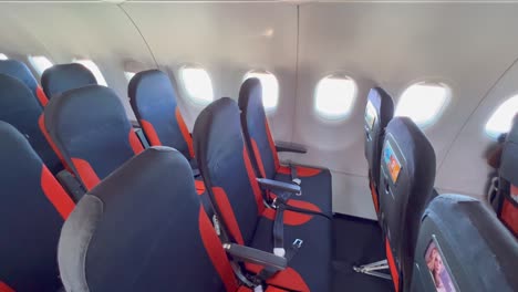 Easyjet-airplane-seats-and-windows-at-an-international-airport,-Easyjet-flying-experience,-people-going-on-a-holiday,-4K-shot