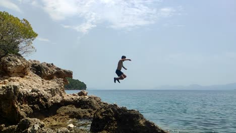 Slow-motion-clip-of-man-jumping-from-cliff-to-water-in-Croatia